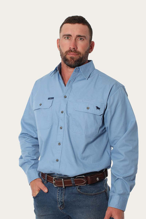 Ringers Western - King River Work Shirt - Blue Denim modeled by a man, showcasing comfort and functionality for outdoor work.