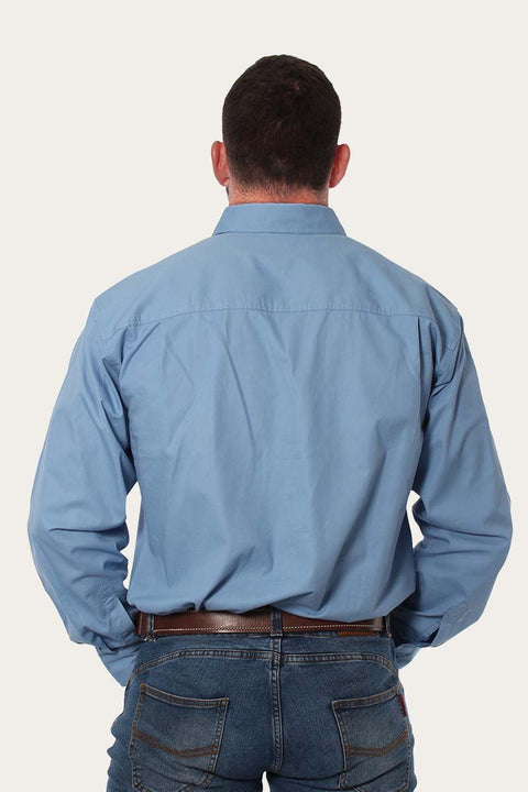 Back view of a man wearing the Ringers Western - King River Work Shirt - Blue Denim, showcasing the comfortable fit.