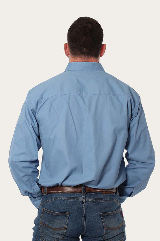 Back view of a man wearing the Ringers Western - King River Work Shirt - Blue Denim, showcasing the comfortable fit.