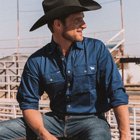 Ringers Western - King River Work Shirt - Navy worn by a model with a cowboy hat, showcasing its style and functionality.
