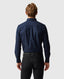 Man wearing a navy blue shirt and black pants on a white background