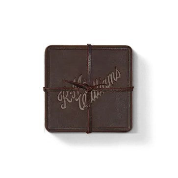 R.M.Williams - Script Logo 4 Piece Coaster Set - Russett displayed as a single piece wrapped with leather tie.