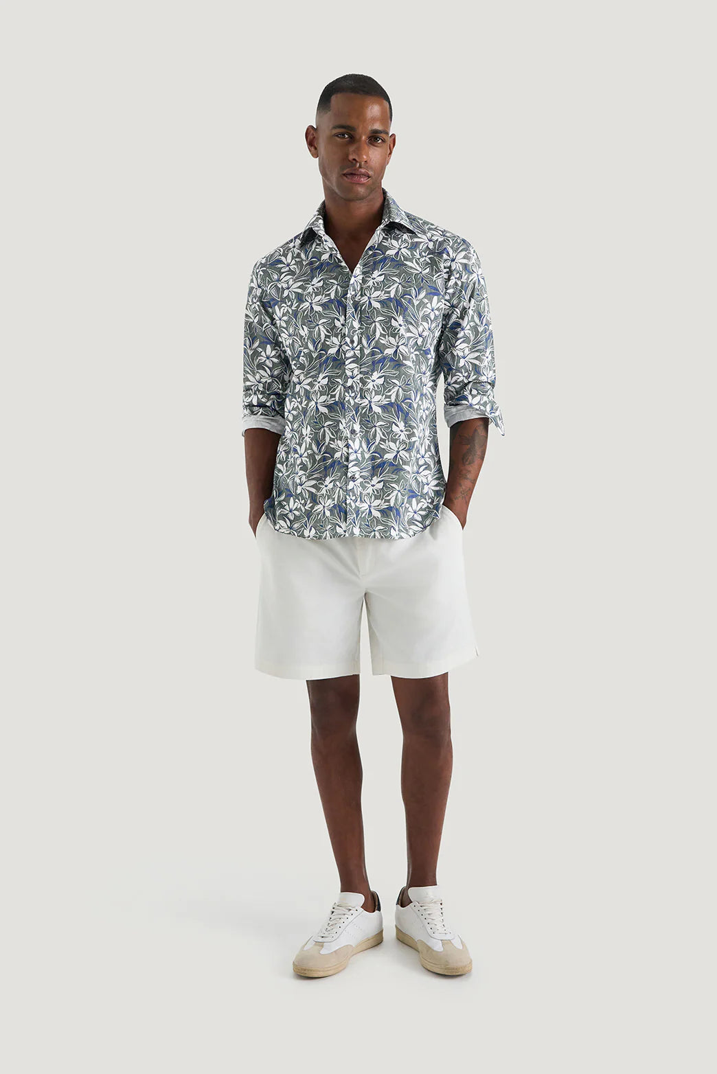 M.J. Bale - Marcello Floral Shirt - Green Navy & White - MULTIBUY worn by model with white shorts and sneakers.
