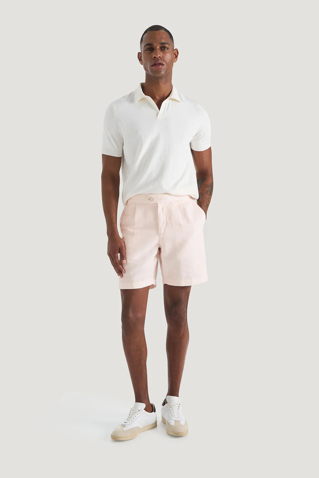 M.J. Bale - Menorca Side Tab Short- Pink worn by a model with a white polo shirt and sneakers.