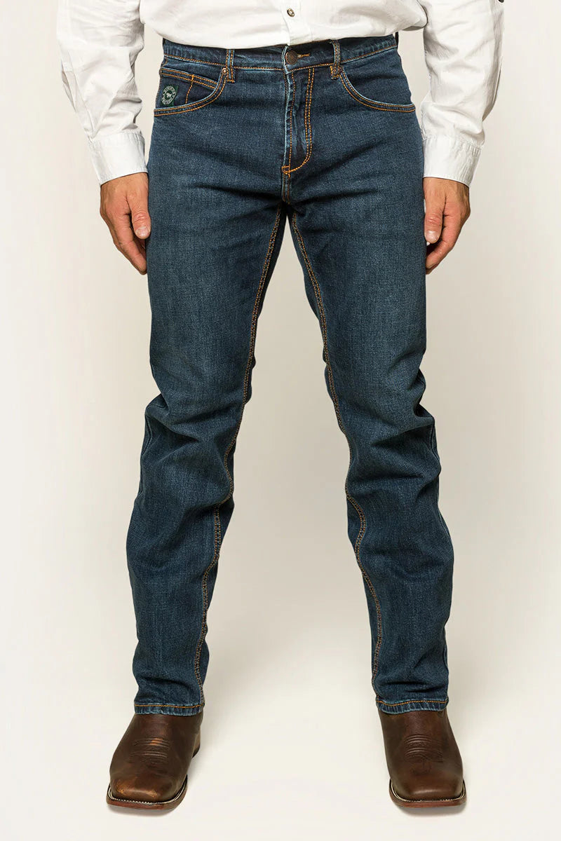 Ringers Western - Muster Slim Straight Fit Jeans- Dark Wash Blue worn by a model standing with hands in pockets.