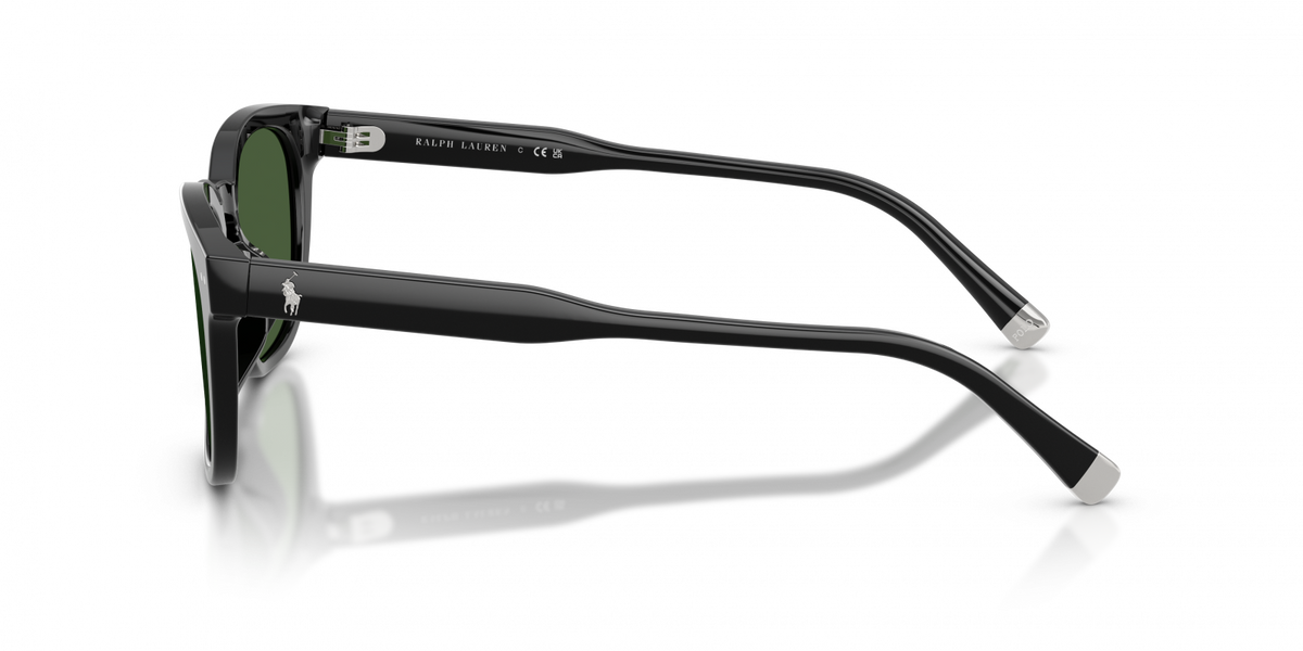 Black acetate sunglasses with green lenses, shown from a side profile view on a reflective white surface.