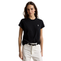 A woman modeling a black short-sleeve crewneck t-shirt with a small white embroidered polo player logo on the left chest, paired with white pants and a black belt, against a plain white background.
