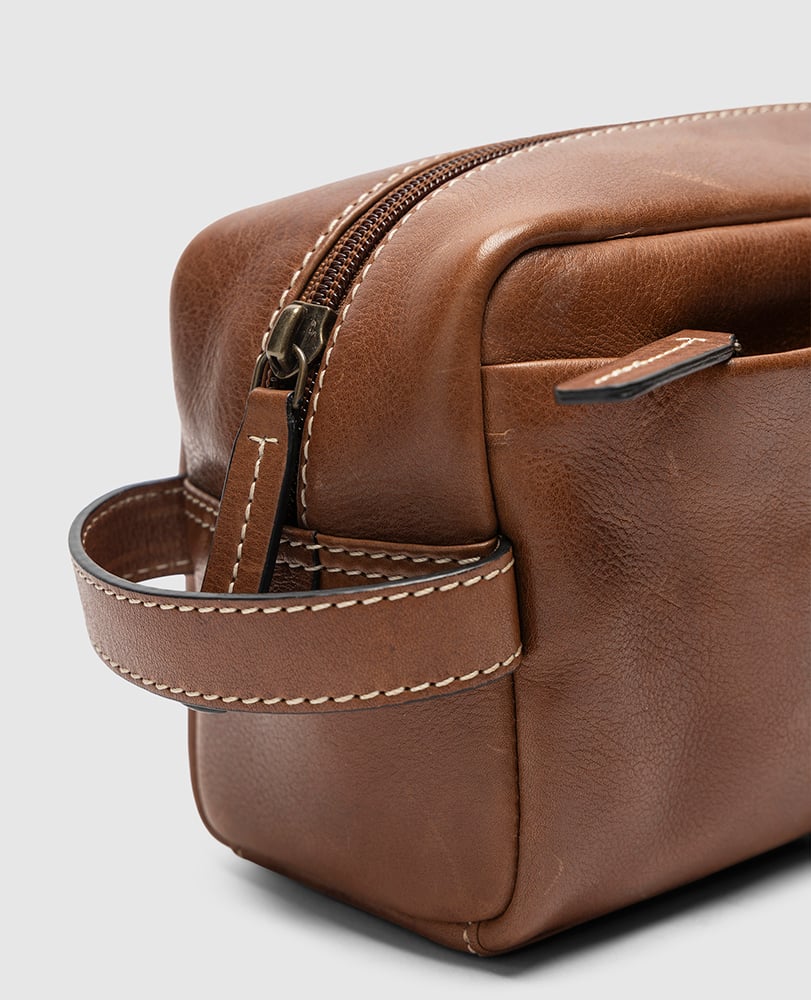 Rodd & Gunn - Princeton Washbag - Cognac side view showing leather details and zip pocket.