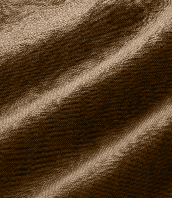 A close-up of draped brown fabric with a soft woven texture and gentle folds.
