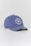 A blue denim baseball cap with a white embroidered circular logo on the front that reads 'Ringers Western' with a cowboy silhouette, set against a plain light gray background.