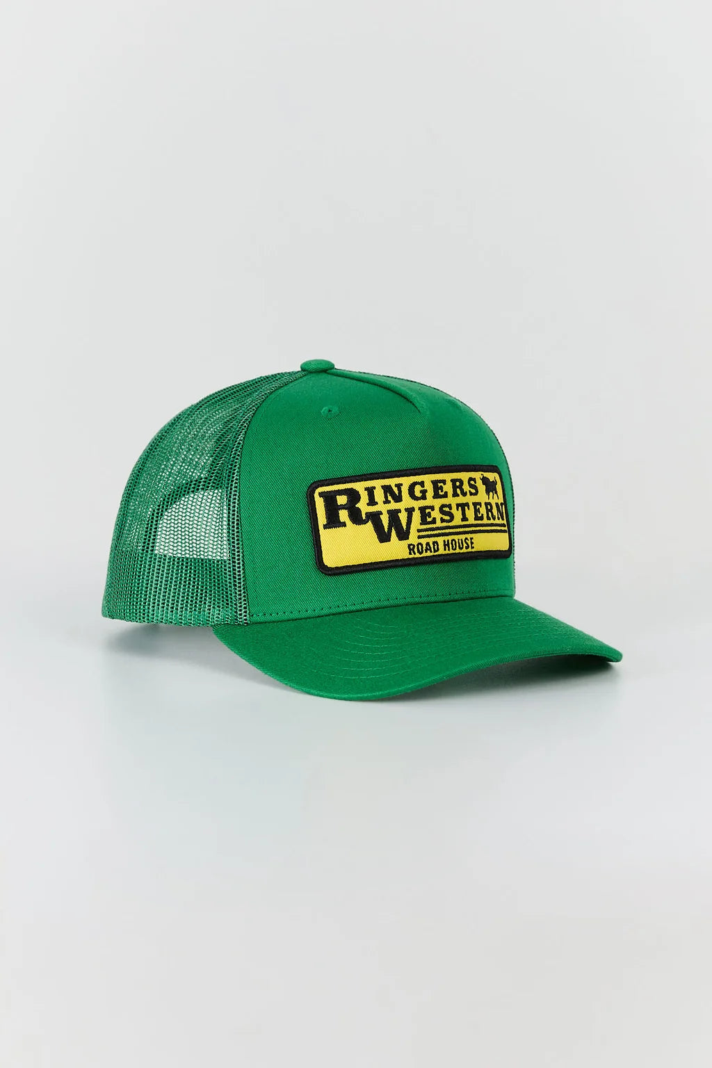 A green trucker hat with a yellow and black 'Ringers Western Road House' patch on the front, set against a plain light gray background.