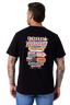 A man wearing a black t-shirt, viewed from the back. The shirt features a large, colorful graphic print on the back with western-themed text and logos, including 'Riders Western' and '2012'.