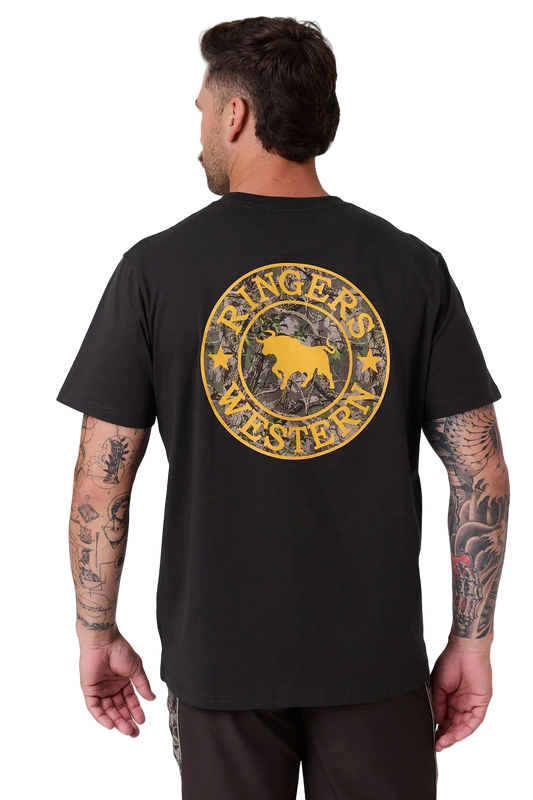 A man viewed from the back wearing a black t-shirt with a large distressed yellow circular graphic on the back that reads 'Ringer's Western' with a bull silhouette. The background is a clean, light gray studio backdrop.