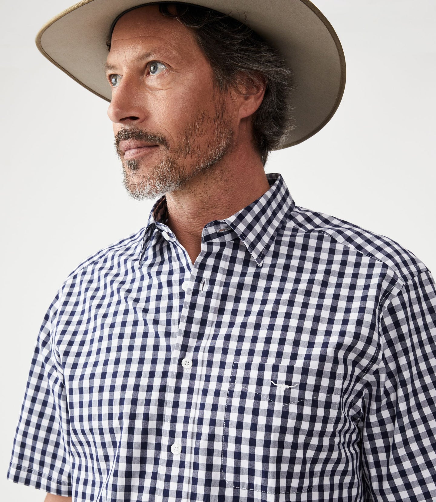 R.M.Williams - Hervey Shirt - Short Sleeve - Check - Navy & White worn by a man, showcasing the durable twill cotton fabric.