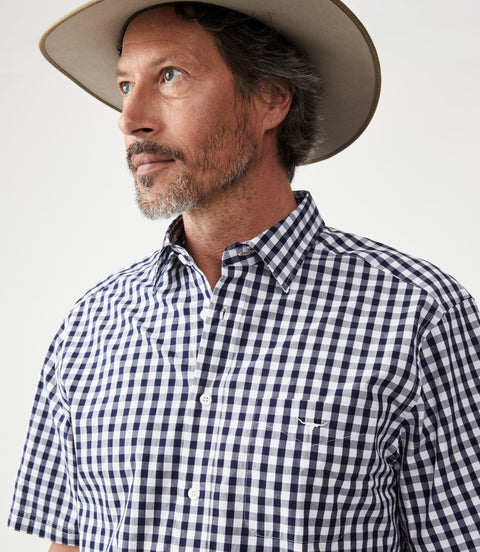 R.M.Williams - Hervey Shirt - Short Sleeve - Check - Navy & White worn by a man, showcasing the durable twill cotton fabric.