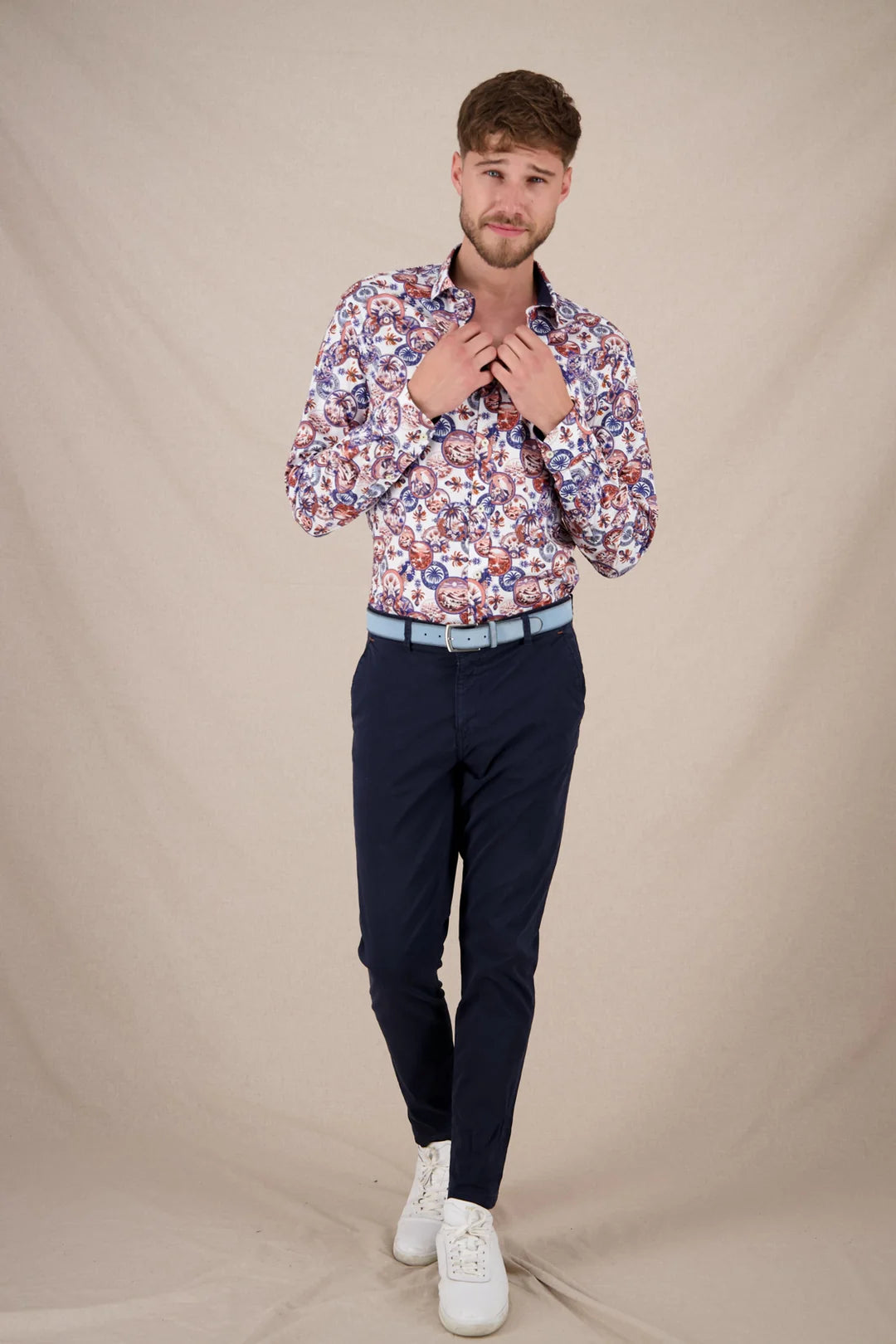 A Fish Named Fred - Desert World Shirt - White & Cobalt Multi worn by a model, styled with navy pants and white shoes.