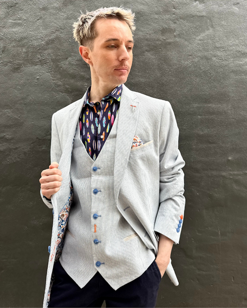 Altemflower - Surfboard Print Shirt - Navy Multi worn under a tailored grey blazer, showcasing vibrant surfboards and a stylish look.