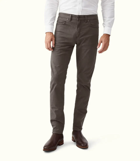 R.M.Williams - Loxton 5 Pocket Jean - Silt worn by a model, showcasing a closer fit and tapered leg, paired with brown boots.
