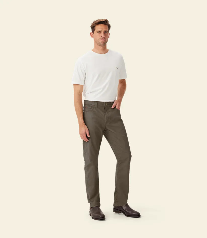 R.M.Williams - Ramco 5 Pocket Jean - Silt model wearing casual outfit with white t-shirt and stylish jeans.