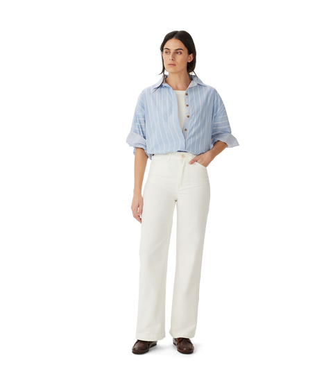 R.M.Williams - Jesse Jean - White modeled with a blue striped shirt and relaxed fit, showcasing premium organic twill jeans.