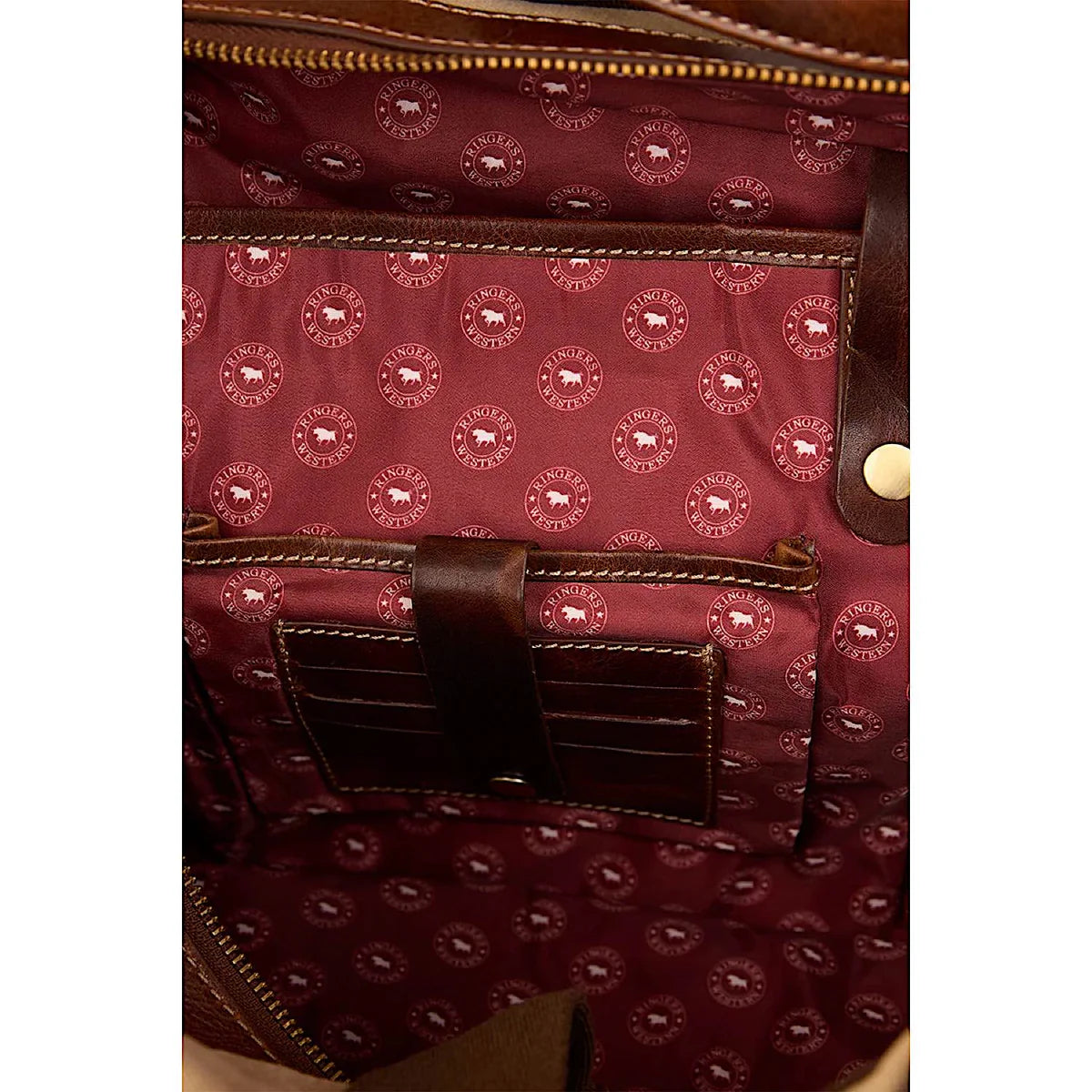 Interior view of Ringers Western - Waxicanvas Duffle Bag - Sand featuring maroon lining and leather accents.
