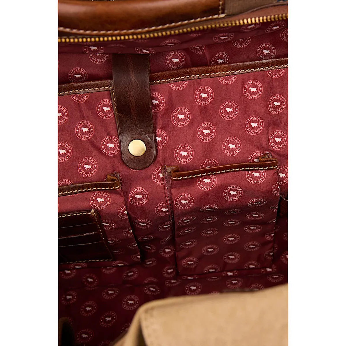 Interior view of the Ringers Western - Waxicanvas Duffle Bag - Sand showcasing pockets and fabric details.