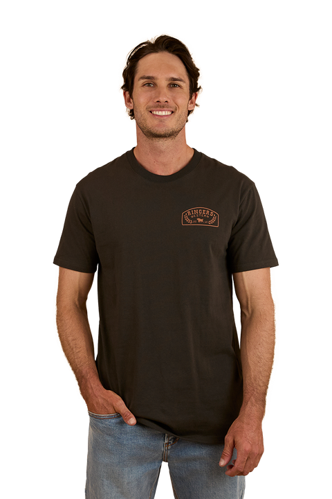 Ringers Western - Wheatbelt Stock Fit T-Shirt- Charcoal/Copper worn by a man, showcasing its casual style and comfort.